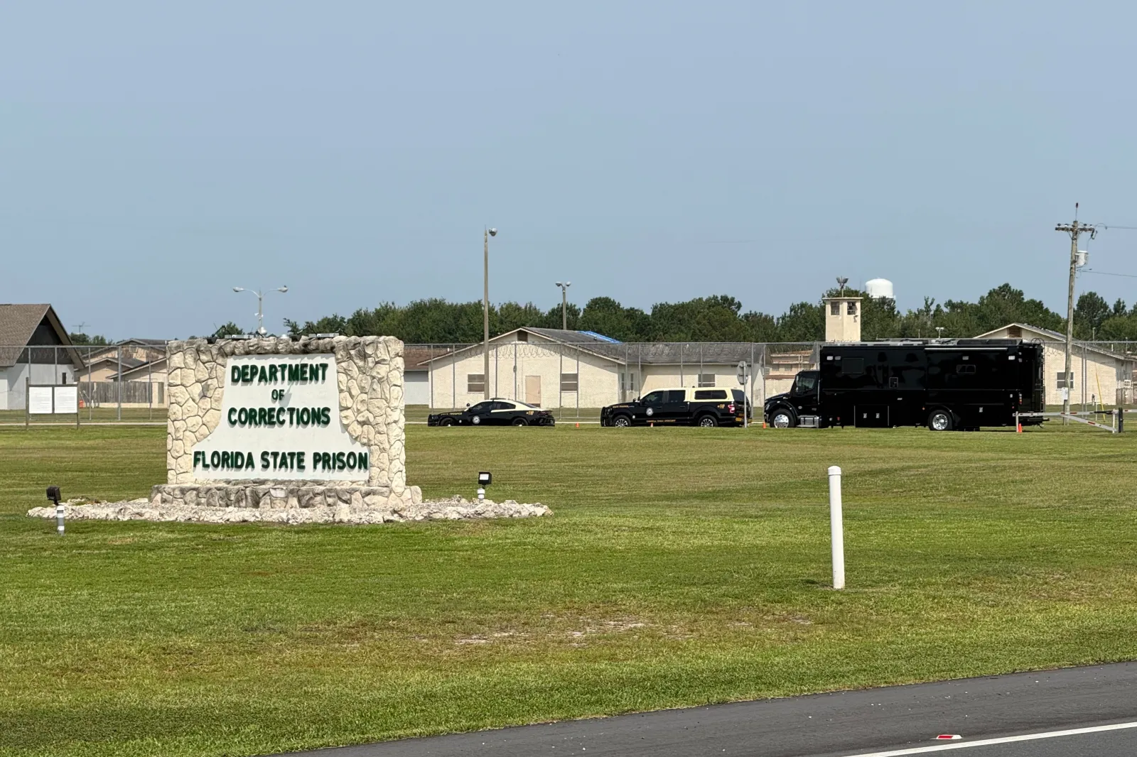 Law enforcement vehicles sit parked outside the Florida State Prison near Starke on July 28. (AP Photo/David Fischer, File)