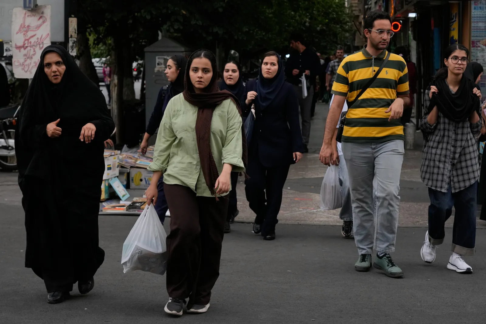 Pedestrians cross an intersection in Tehran on October 6, 2026.