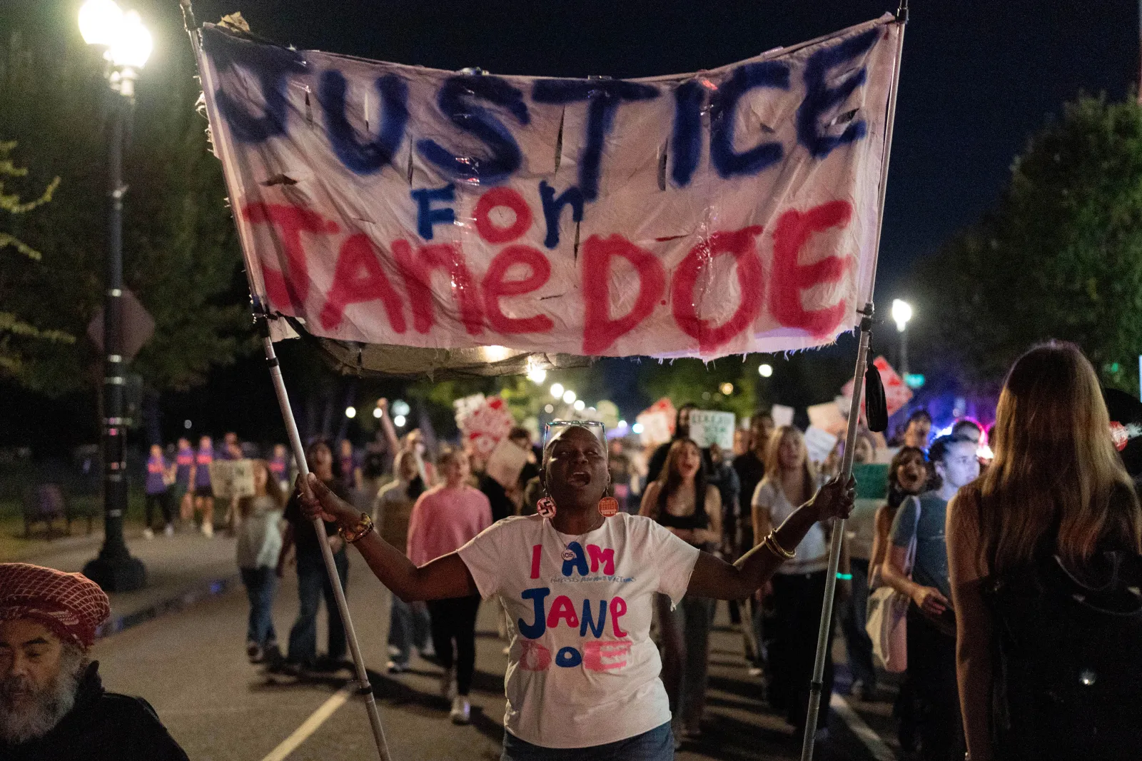Demonstrators march from the Washington Monument to the White House during a "Stop Sexual Violence" protest in Washington on October 8, 2026.