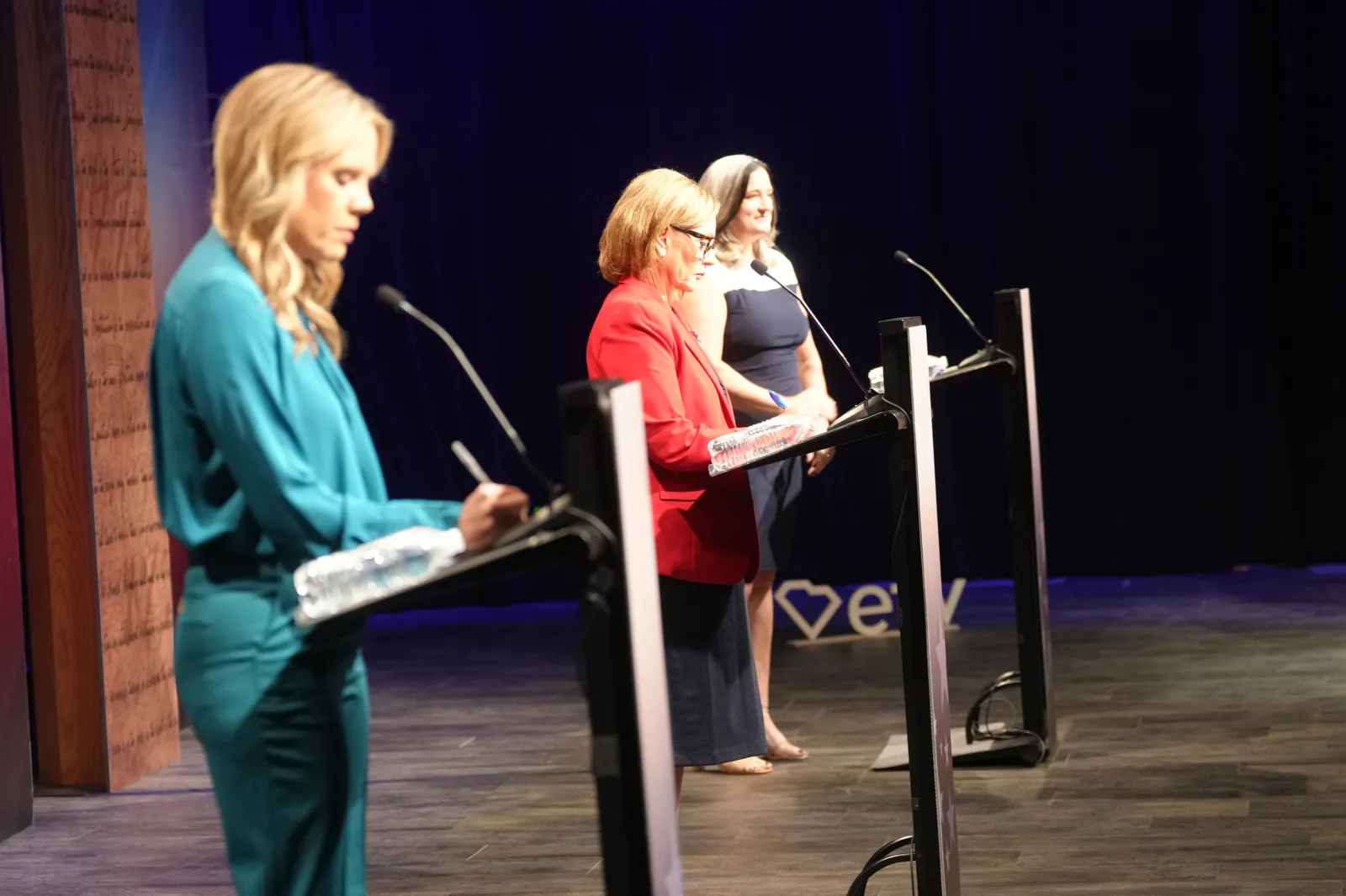 From left, Dr. Annie Andrews, Democratic nominee for Senate in South Carolina, Republican Senator Darline Graham and Libertarian candidate Kasie Whitener ready for a debate Sunday, October 11, 2026, in Columbia, South Carolina.