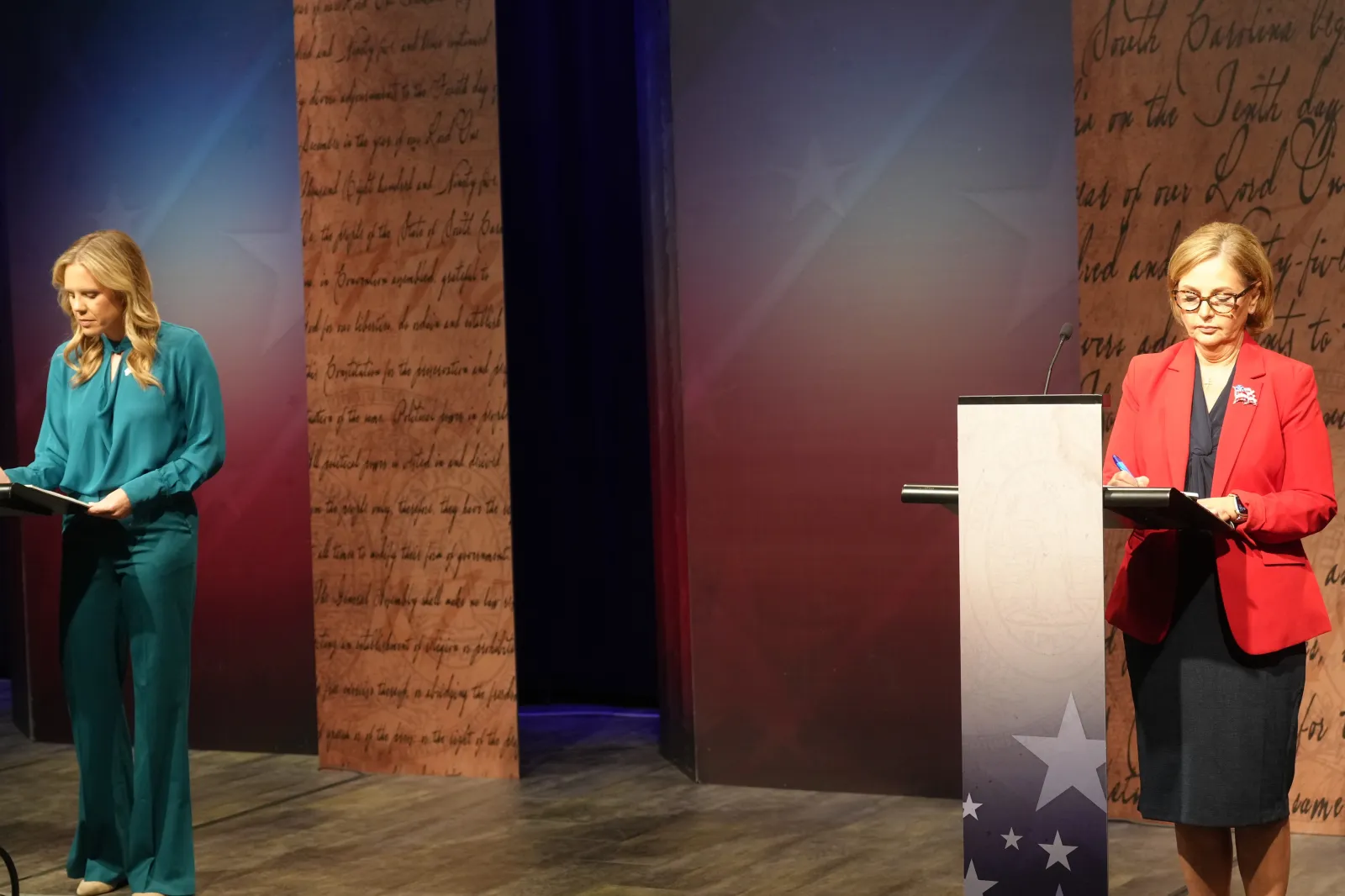 Dr. Annie Andrews, Democratic nominee for Senate in South Carolina, left, and Sen. Darline Graham, R-S.C., write notes ahead of a debate Sunday, Oct. 11, 2026, in Columbia, S.C. (AP Photo/Meg Kinnard)