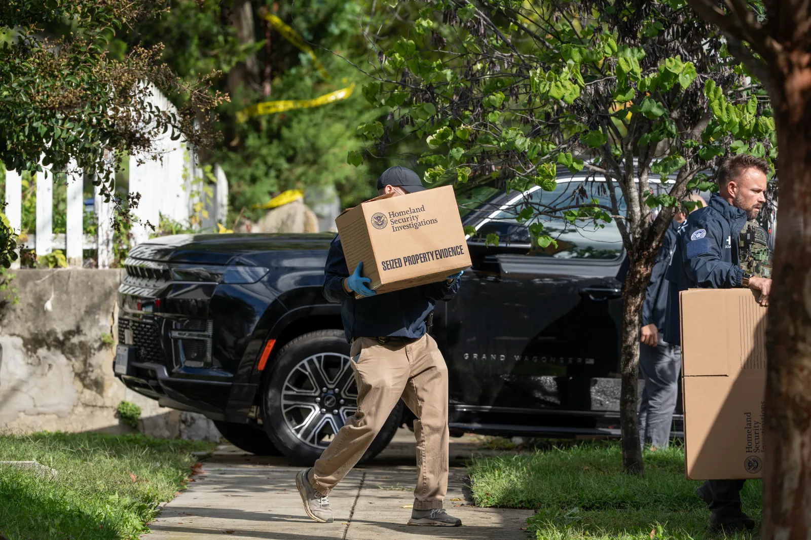 Homeland Security Investigations officers carry boxes from the Washington, D.C., home of Democratic Congresswoman Ilhan Omar during a search on Monday. (AP Photo/J. Scott Applewhite)