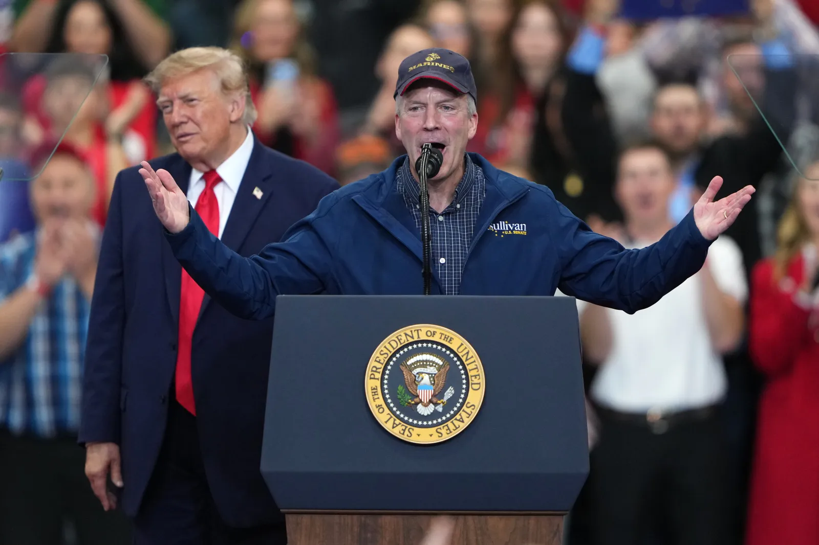 President Donald Trump listens as Senator Dan Sullivan speaks at a campaign rally at the Curtis D. Menard Memorial Sports Center on October 13, 2026, in Wasilla, Alaska.