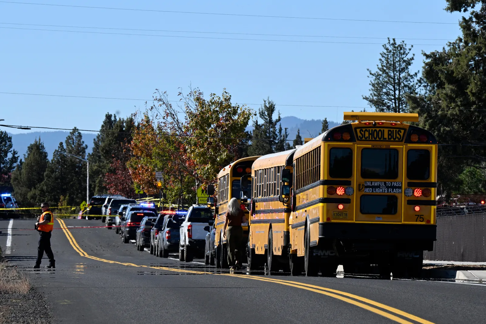 School buses are lined up outside Silver Rail Elementary school, where a shooting took place, on Thursday, Oct. 15, 2026 in Bend, Ore. (AP Photo/Joe Kline)