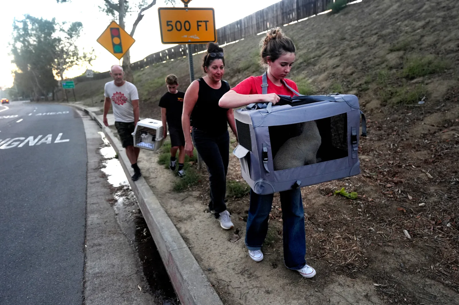 The Hagg family return home with their cats after the Norte Fire on Friday, October 16, 2026, in San Juan Capistrano, California.