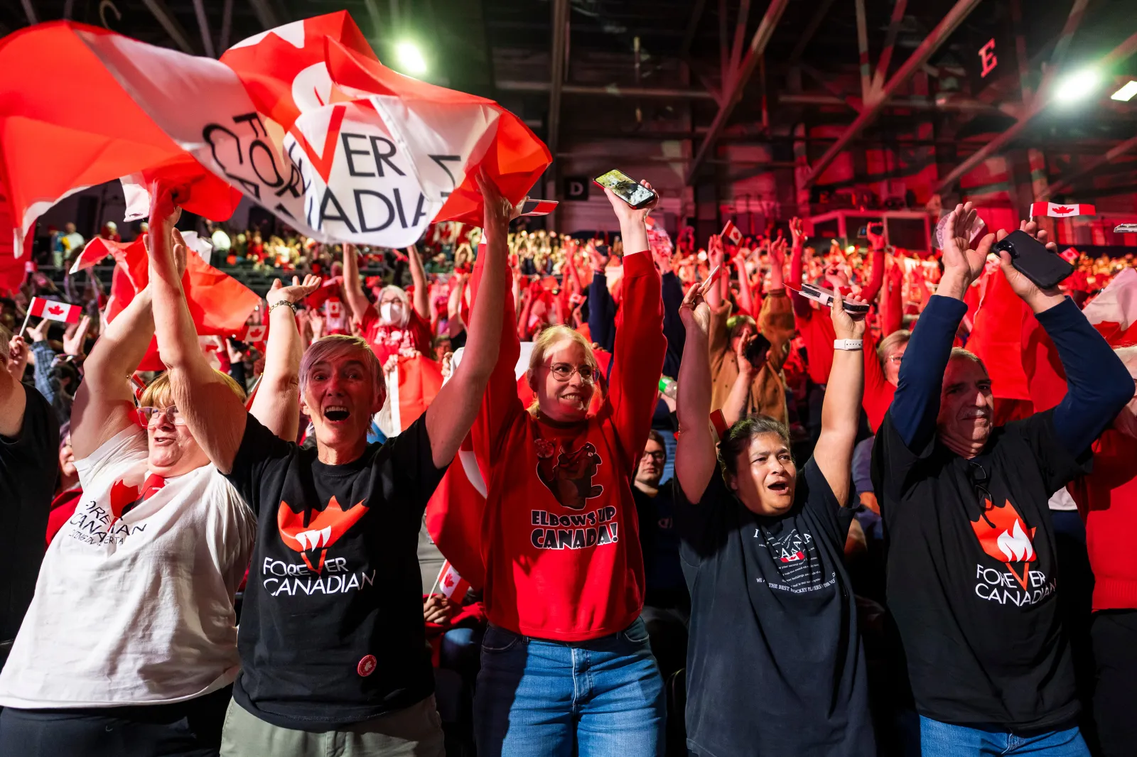 People cheer at a Forever Canadian rally in Edmonton, Canada, on Friday.