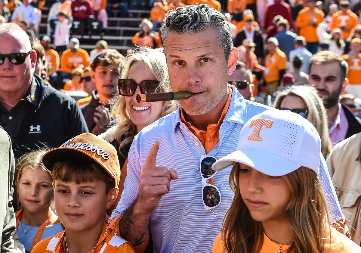 U.S. Defense Secretary Pete Hegseth poses with a cigar before the college football game between the Tennessee Volunteers and the Alabama Crimson Tide on October 17, 2026, at Neyland Stadium in Knoxville, Tennessee.