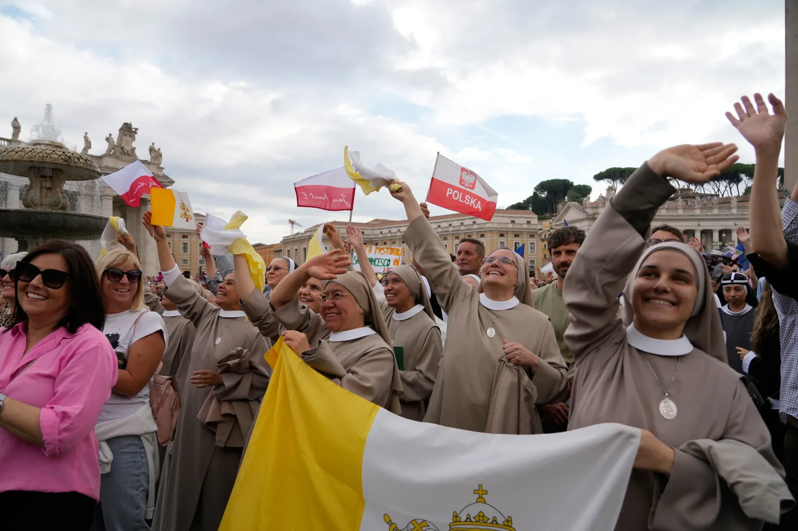 Faithful watch Pope Leo XIV appearing at the window of his study in the Apostolic Palace overlooking St. Peter's Square at the Vatican for the traditional noon blessing after praying the Angelus, on October 18. | AP Photo/Gregorio Borgia