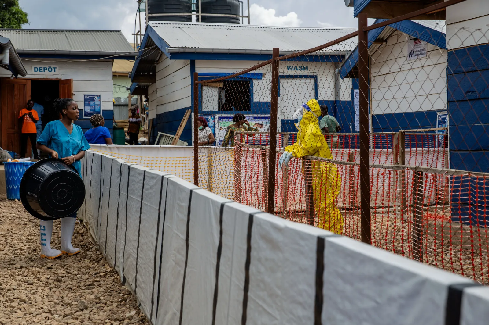 A healthcare worker speaks to a colleague at the Ebola treatment center in Beni, North Kivu province, Congo, on October 19, 2026. (AP Photo/Sebastien Kitsa Musayi)