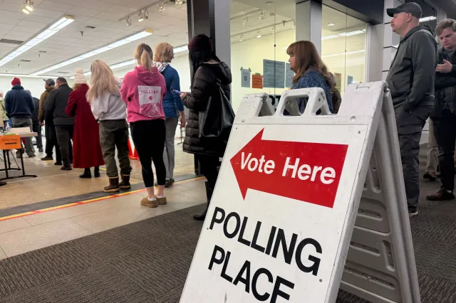 This photo taken with a smart phone, voters stand in line at an early voting location in a mall in Anchorage, Alaska, on Wednesday, Oct. 21, 2026.