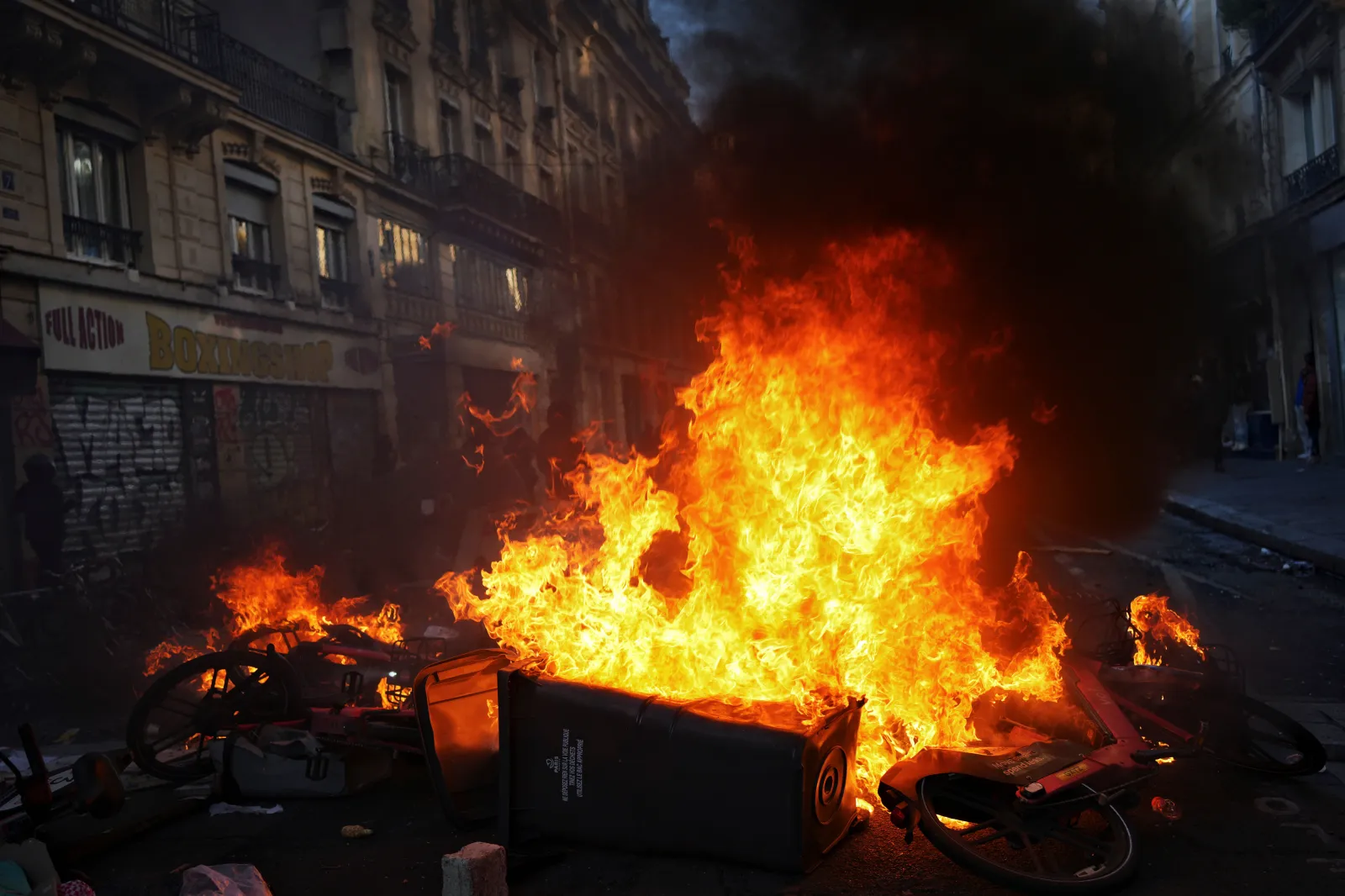 Flames rise from burning debris during a protest in Paris on October 18.