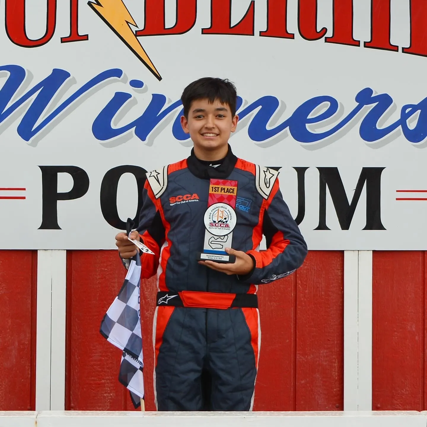 Asad Nikadambaev holds a first place trophy after winning the feature race at Thunderhill Raceway Park in Willows, CA in Spec Racer Ford Gen 3 (SRF3) class - 25 October, 2025.
