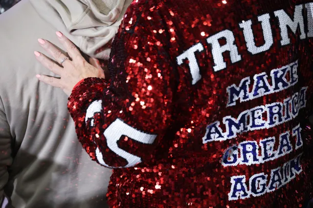 A person wears a jacket that reads "TRUMP MAKE AMERICA GREAT AGAIN" as U.S. President Donald Trump speaks on stage during an election rally at the Oncenter on October 09, 2026 in Syracuse, New York.