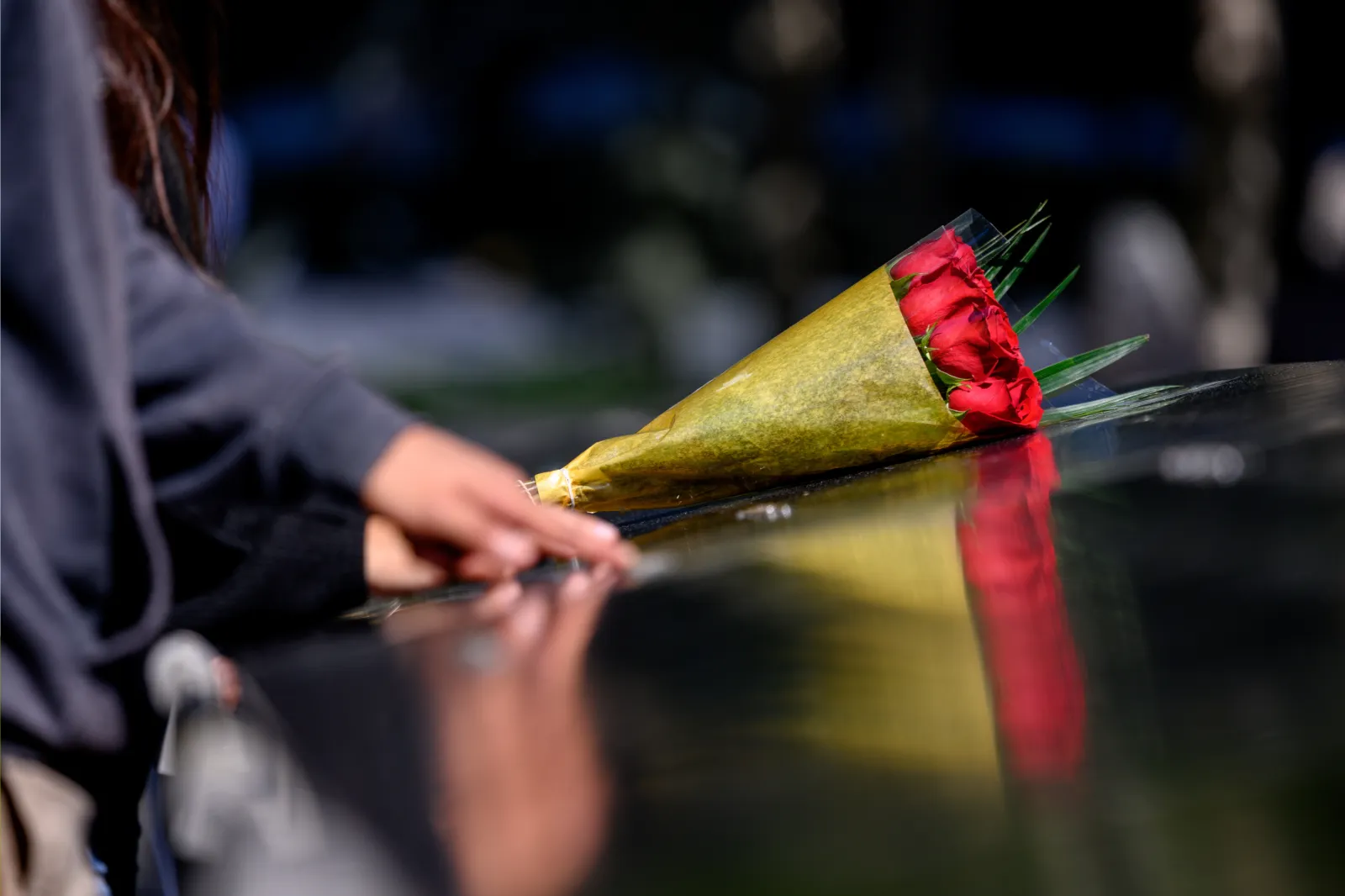 Visitors leave flowers on the September 11 memorial at the World Trade Center in lower Manhattan on September 29, 2021, in New York City.