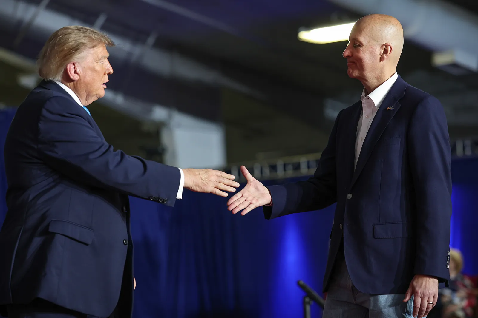 Trump greets Ricketts during a campaign rally at Pinnacle Bank Expo Center on the Nebraska State Fairgrounds on October 05, 2026, in Grand Island, Nebraska.