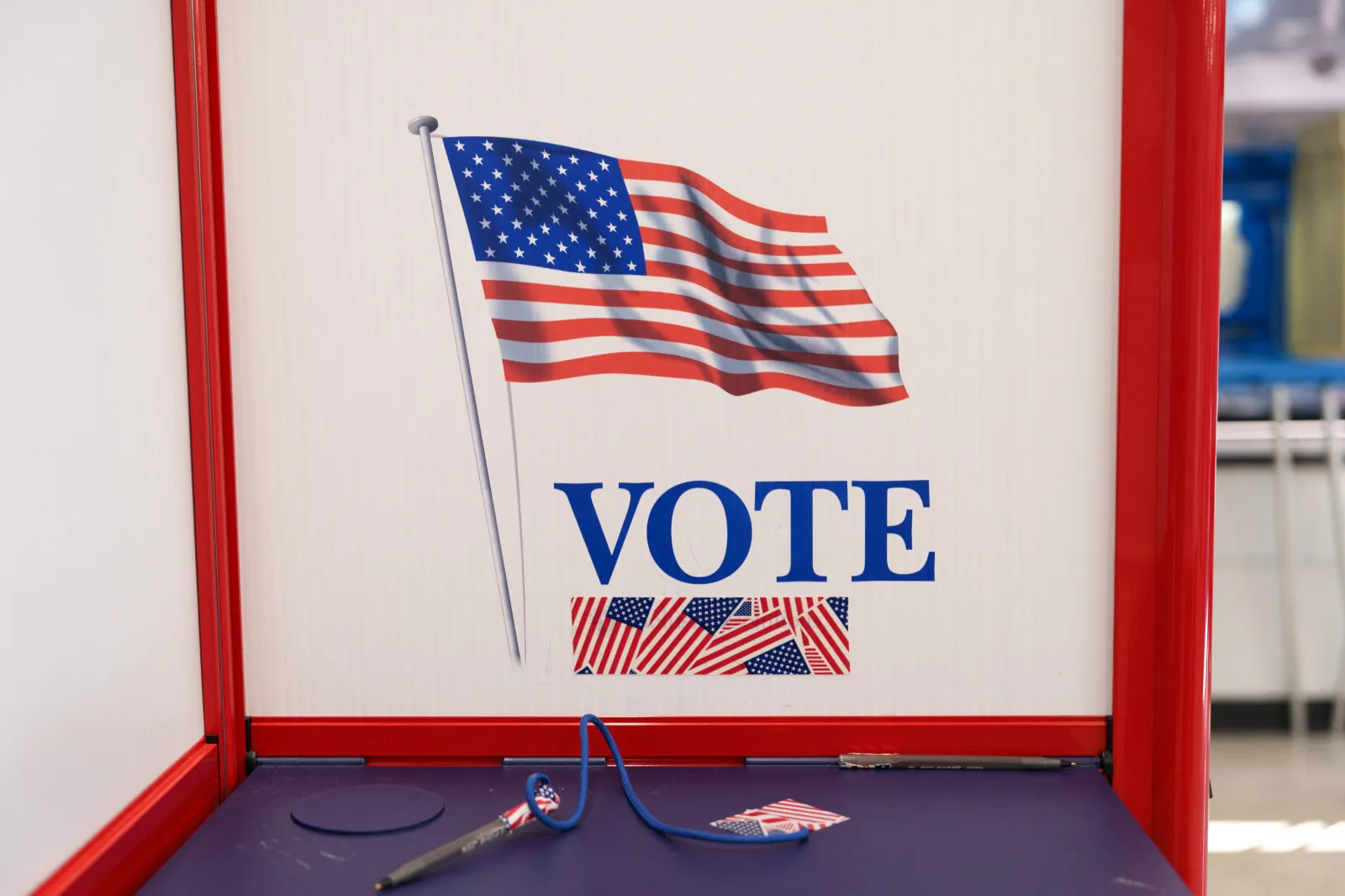 An American flag decorates a privacy booth at a polling station during the first day of early voting for the midterm elections in Minneapolis, Minnesota, on October 16, 2026.