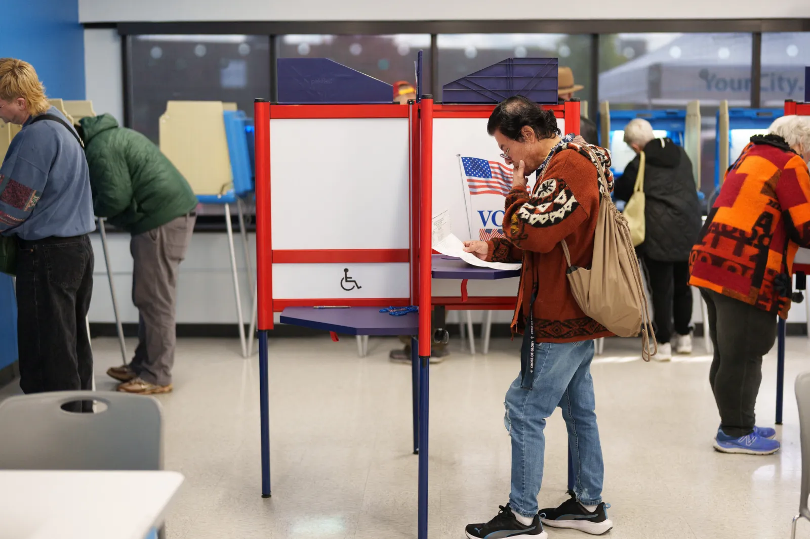 People fill their ballots during the first day of early voting for the midterm elections in Minneapolis, Minnesota, on October 16, 2026.