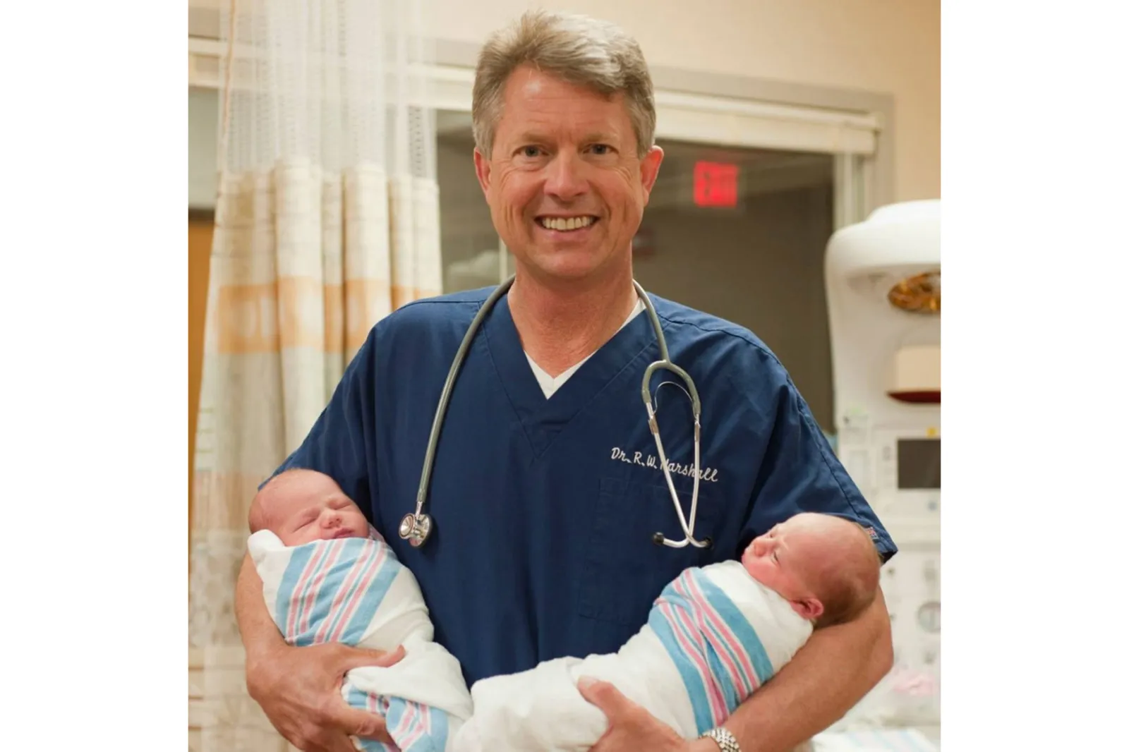 Photo of Marshall holding two babies, which was taken from his official campaign website.