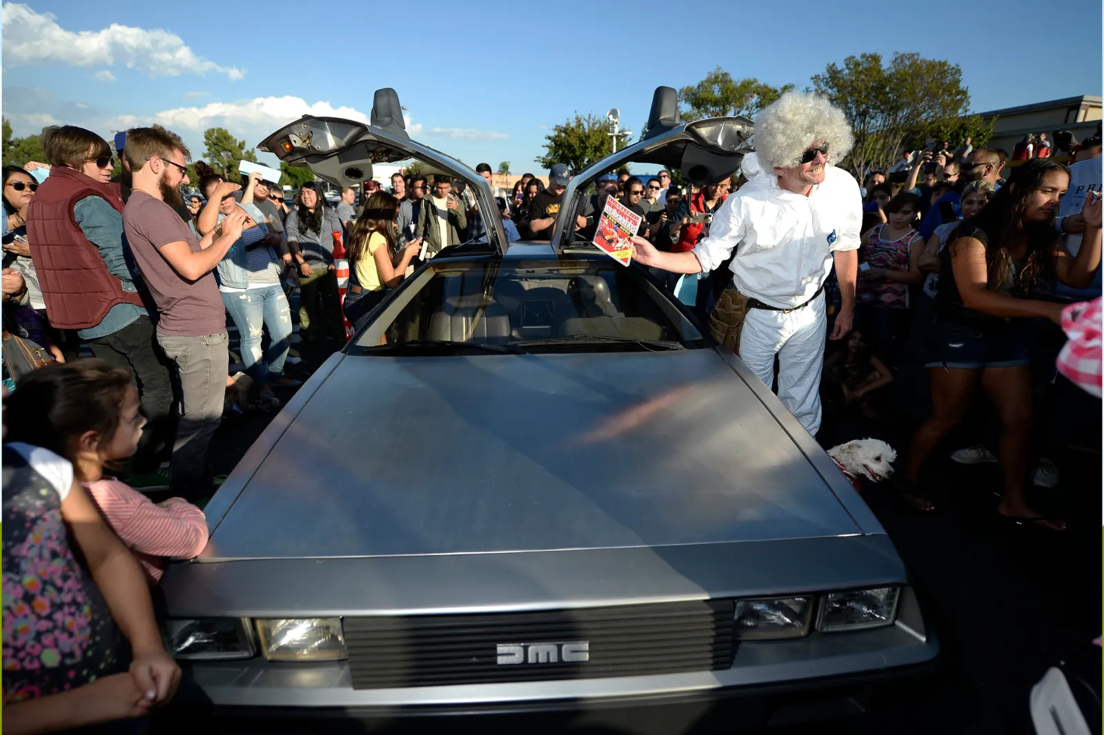 Fans gather around a DeLorean car parked next to Dr. Brown's truck in the Puente Hills Mall during the "Back To The Future" Day event on October 21, 2015, in City of Industry, California.