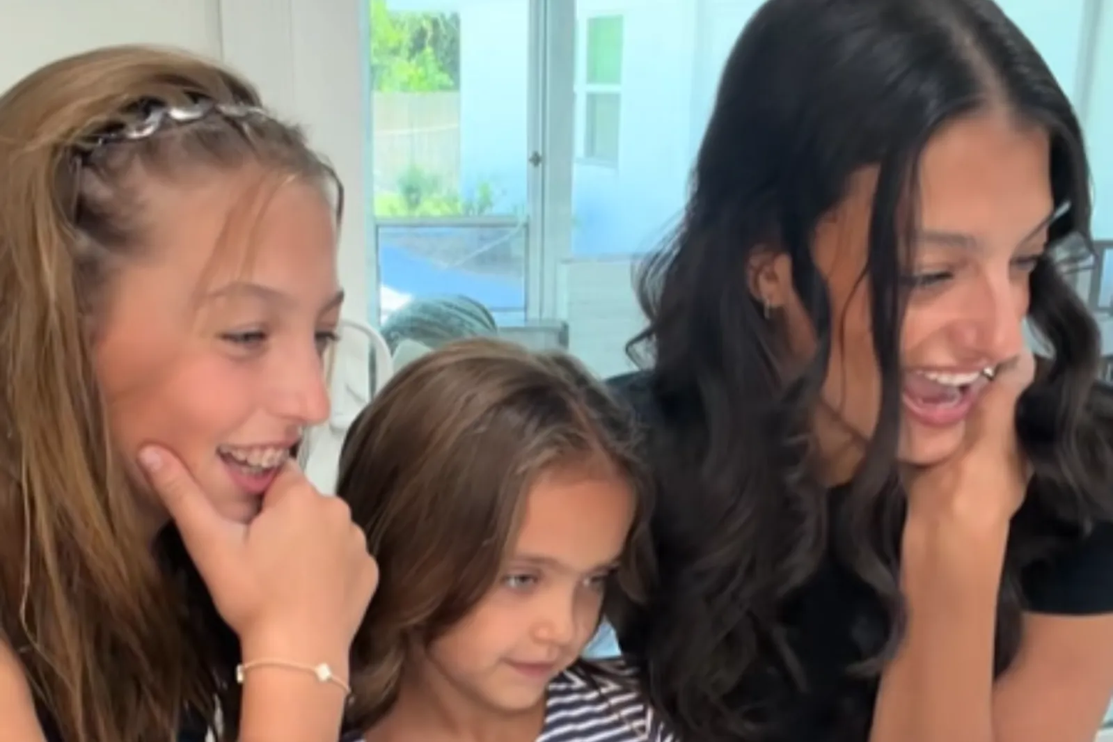 From left: Hallie, 13, Agnas, 7, and Tara Johnson look at DNA test results on a laptop computer.
