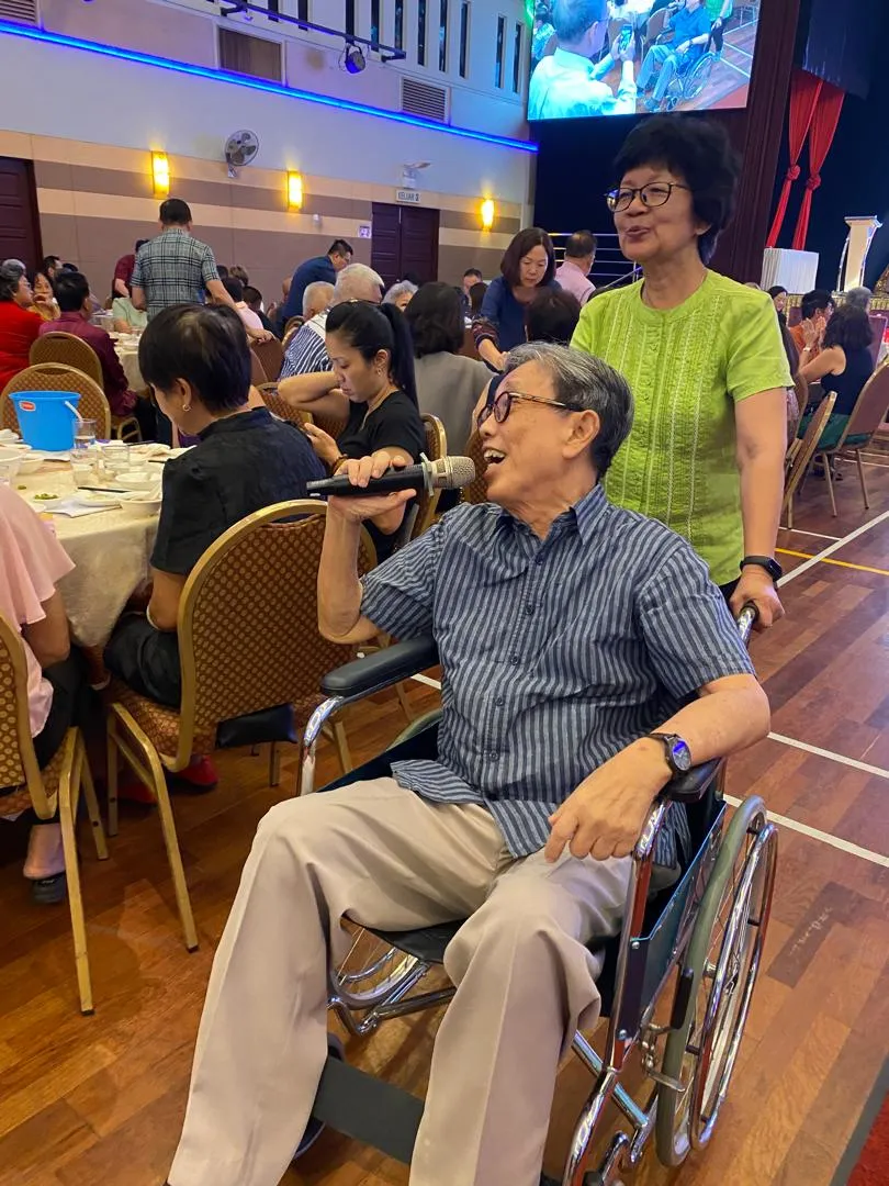 Yoong's father with a nurse at a hospice gala.