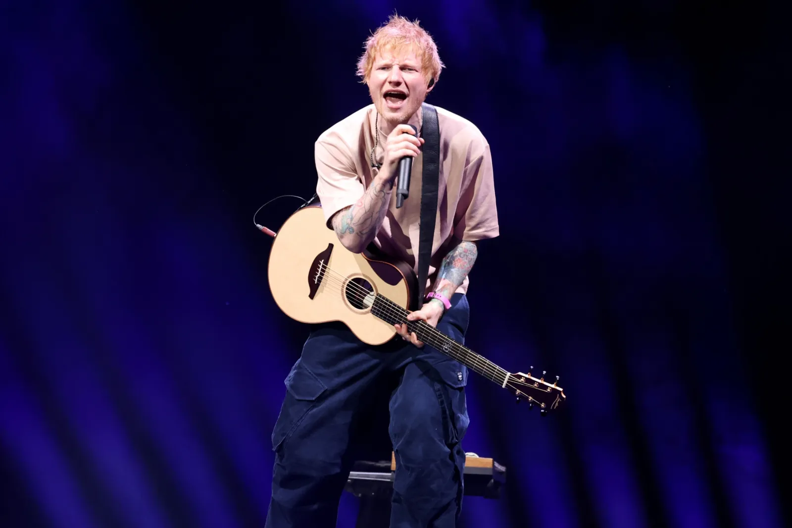 Ed Sheeran performing at iHeartRadio KISS108's Jingle Ball 2025 in Boston.