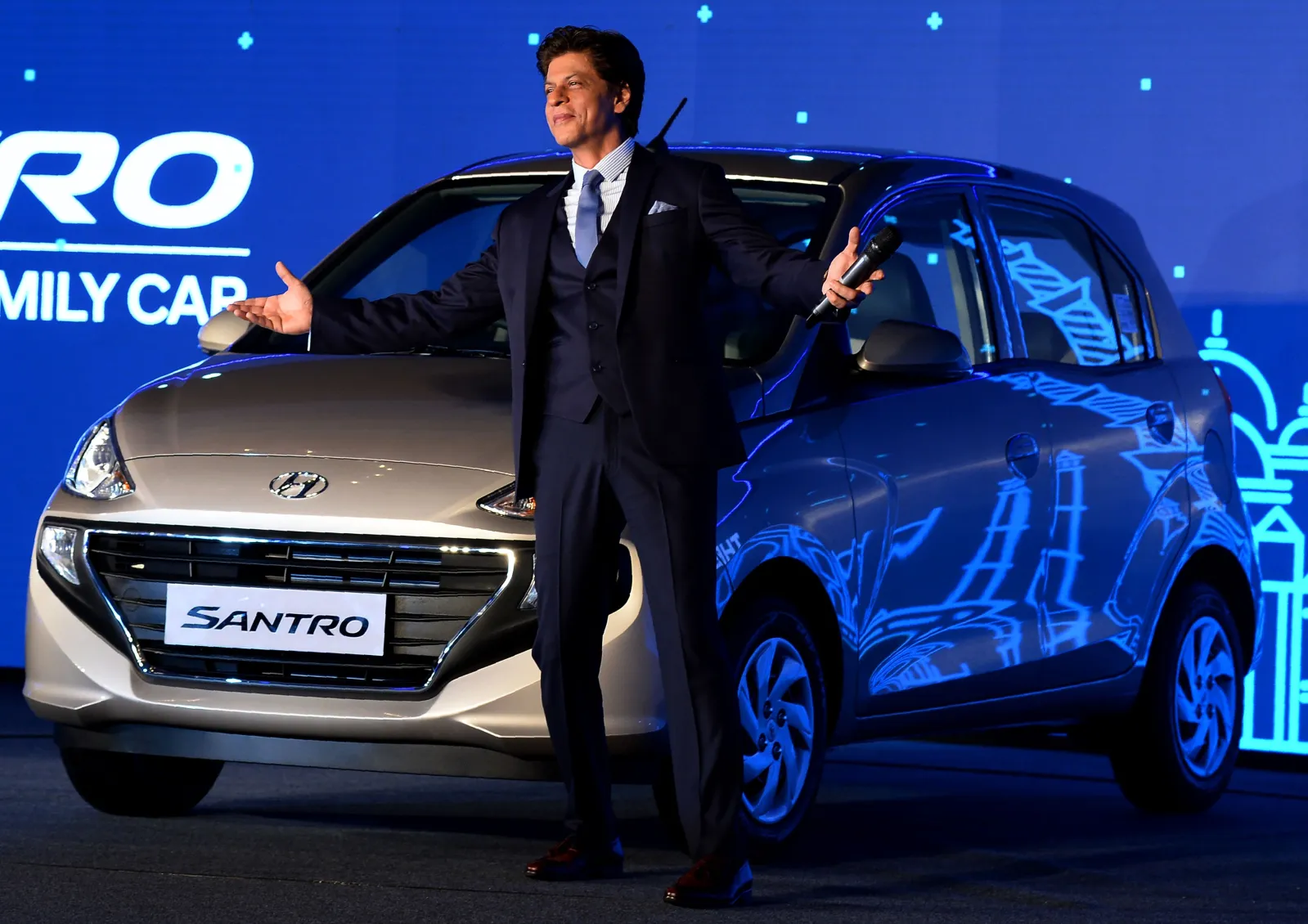 Indian Bollywood actor and brand ambassador for Hyundai Motors India Shah Rukh Khan poses for a picture next to the newly relaunched Hyundai Santro car at an event in New Delhi on October 23, 2018.