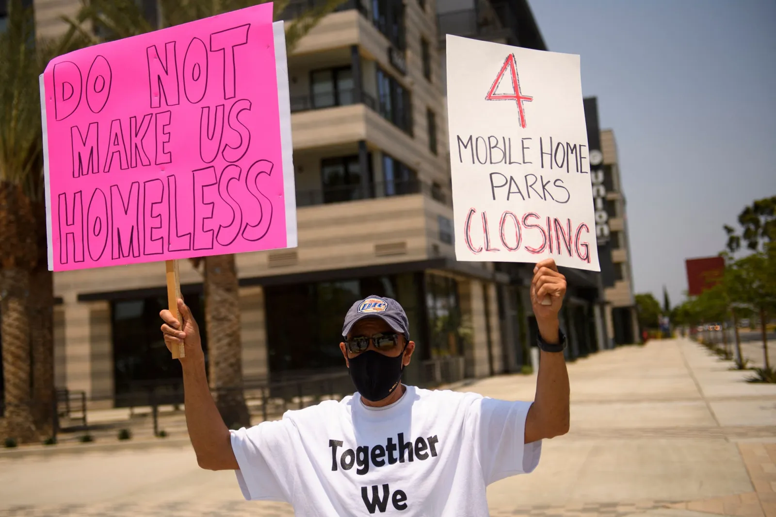 People protest a lack of affordable housing and the valuations of their manufactured homes by land owners outside of Carson City Hall in Carson, California in July 2021.