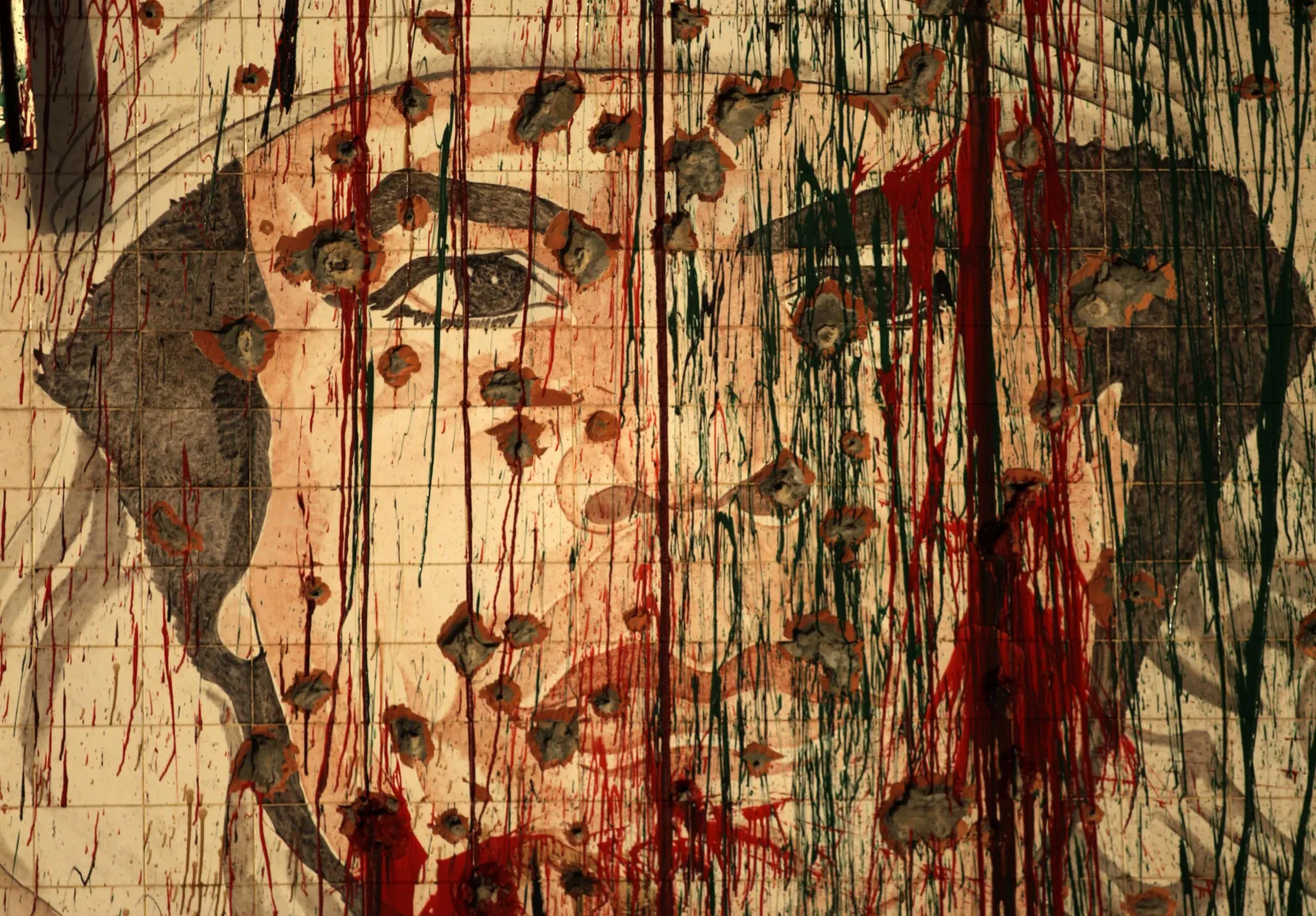A defaced portrait of Libyan leader Muammar el-Qaddafi is pictured in Tripoli on September 1, 2011, weeks before his killing by advancing rebels.