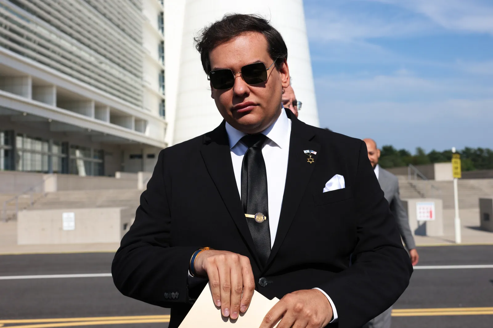 Former U.S. Representative George Santos, a New York Republican, prepares to give a statement after a court hearing on August 19, 2024, in West Islip, New York. (Michael M. Santiago/Getty Images)