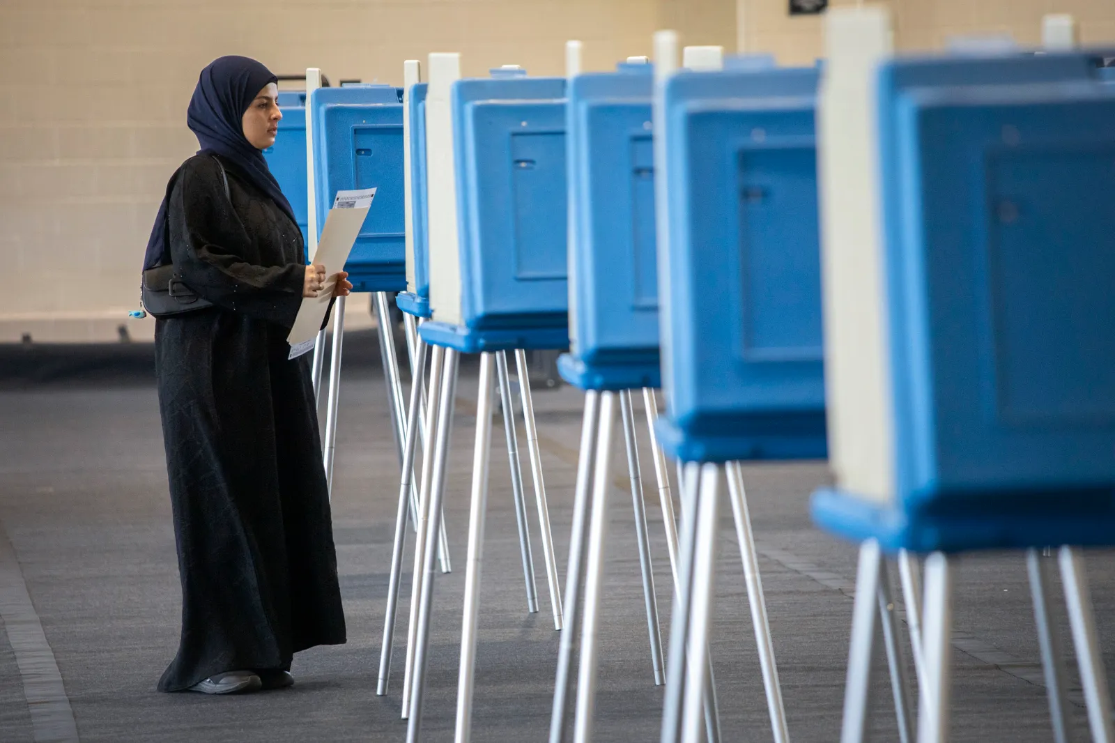 A voter casts her ballot during Michigan's early voting period on October 29, 2024, in Dearborn. (Photo by Bill Pugliano/Getty Images)
