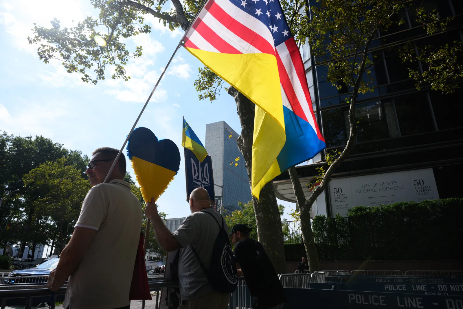 People wave Ukrainian symbols and an American-Ukrainian flag outside the 80th session of the UN’s General Assembly (UNGA) on September 23, 2025, in New York City.