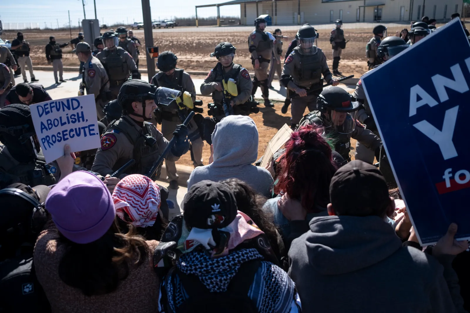 Texas State Troopers push protestors and deploy pepper balls during a protest against Immigration and Customs Enforcement outside the South Texas Family Residential Center on January 28, 2026, in Dilley, Texas. (Photo by Joel Angel Juarez/Getty Images)