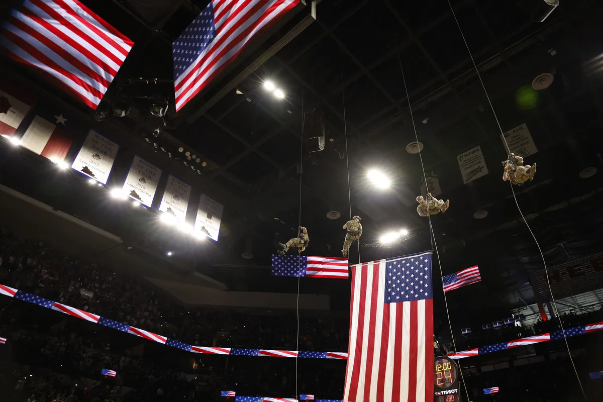 U.S. Air Force Special Warfare operators from the 353rd Special Warfare Training Squadron rappel from the stadium roof before a game at Frost Bank Center in San Antonio on March 14, 2026.