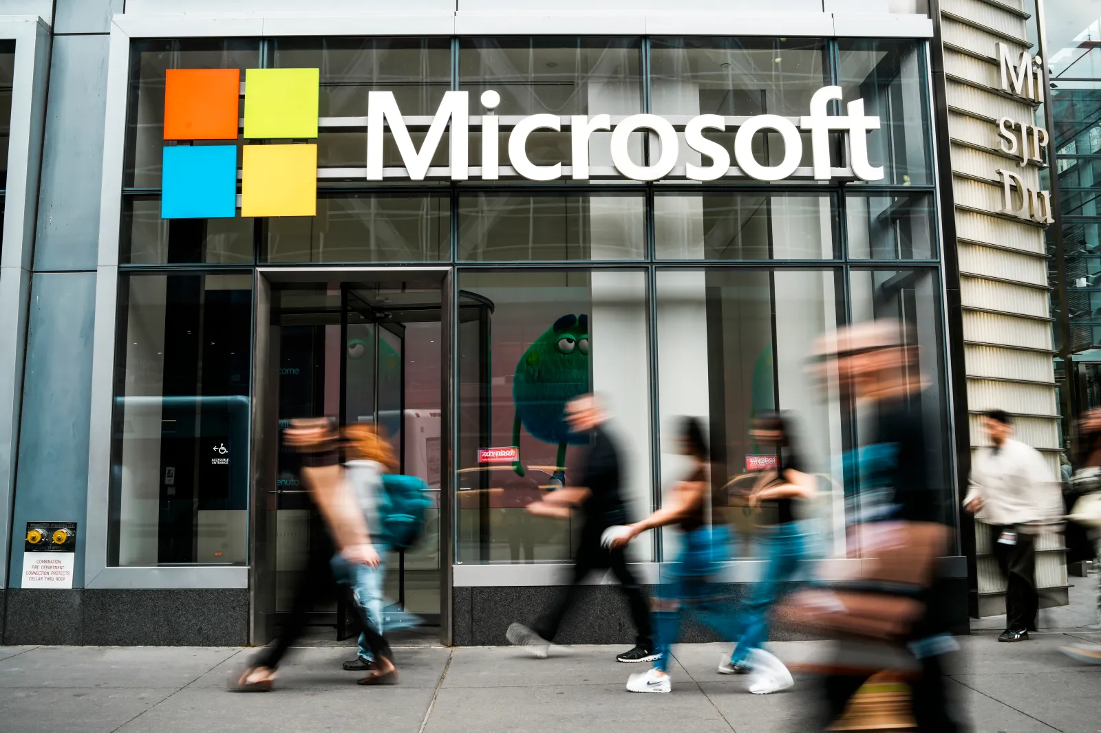 People walk in front of a Microsoft store in Manhattan on March 31, 2026.