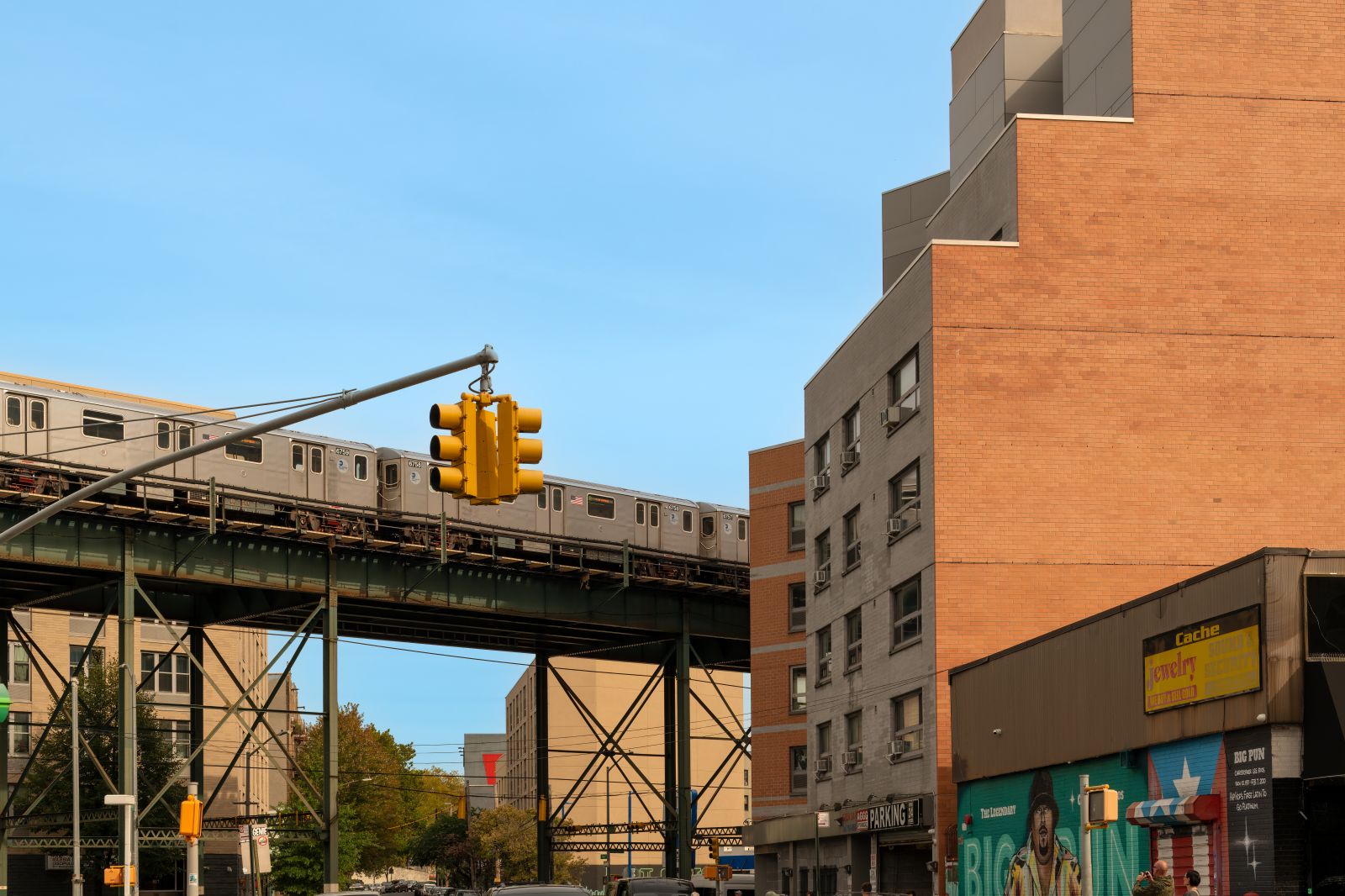A blend of transportation infrastructure and vibrant street murals on local storefronts is depicted in this picture of New York City's Bronx borough on Septembe