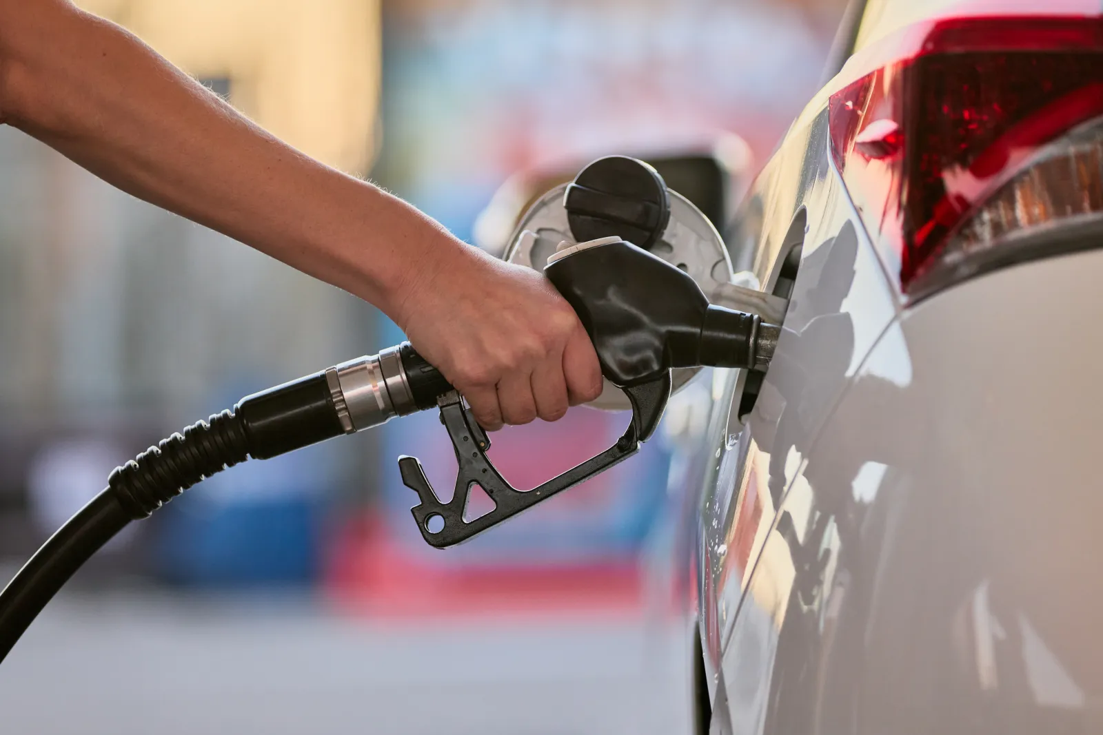 Stock image of a person refueling their car.