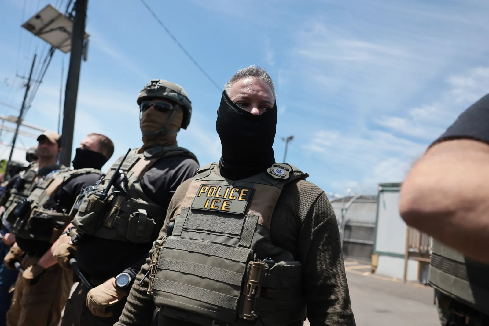 ICE agents stand guard in front of protesters outside Delaney Hall, which is being used as an detention centre in Newark, New Jersey.