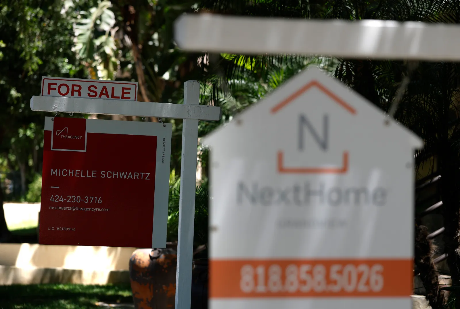 "For Sale" signs are posted in front of condominiums on July 9 in Los Angeles.