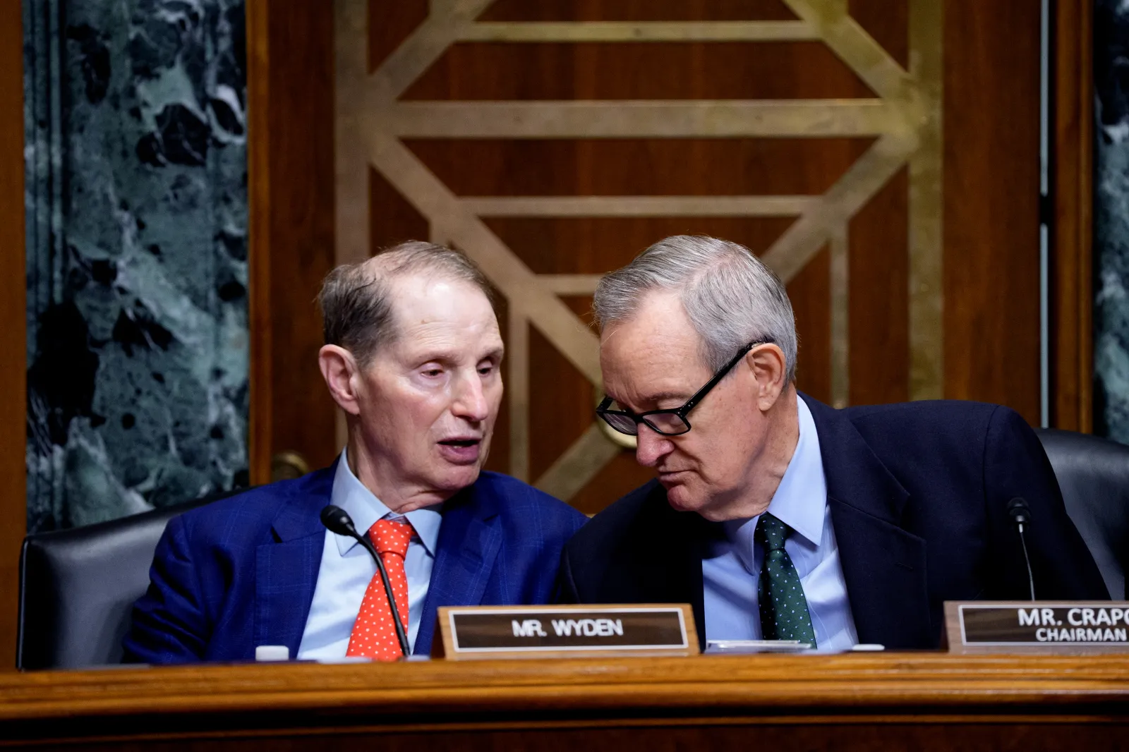 Chairman Mike Crapo (R-ID) (R) and Ranking Member Sen. Ron Wyden (D-OR) (L) speak during a Senate Finance Committee hearing with U.S. Trade Representative Jamieson Greer on July 22, 2026, in Washington, D.C. (Photo by Andrew Harnik/Getty Images)