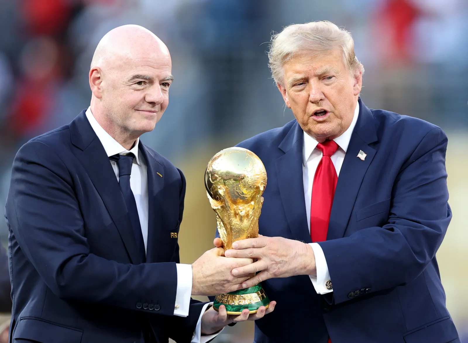President Donald Trump and FIFA President Gianni Infantino hold the FIFA World Cup Winner's Trophy at the award ceremony following the FIFA World Cup 2026 final at New York New Jersey Stadium on July 19, 2026.