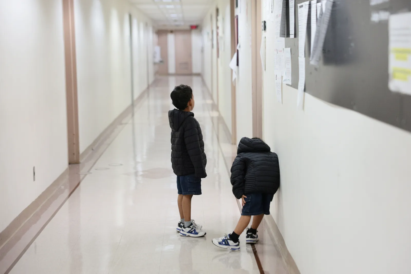 Children wait outside of an immigration court at the Jacob K. Javits Federal Building on July 31, 2026, in New York City.
