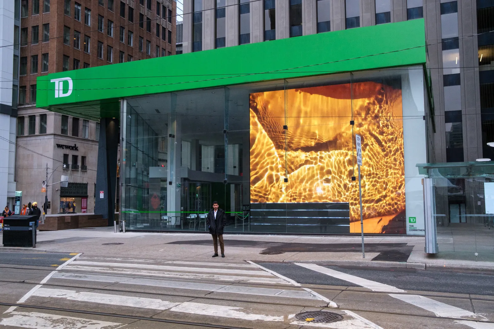 A street-level view of a TD bank branch and commercial building facade near Nathan Phillips Square in Toronto, Ontario, Canada, on April 30, 2023.