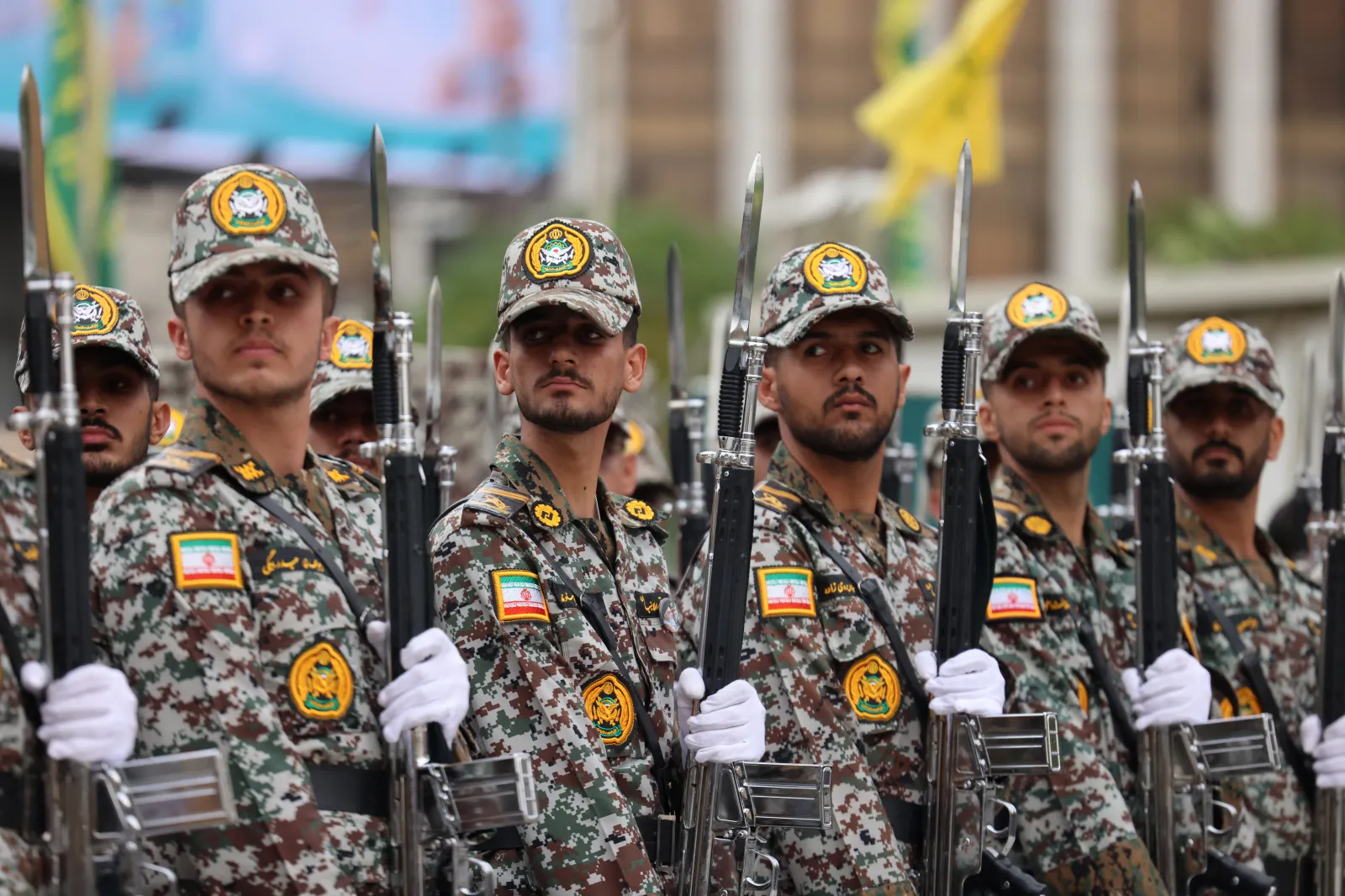 Iranians in camouflage stand at attention during the inauguration of a training center by the Iranian army for "Jan-Fadayan" volunteers, at Haft-e-Tir Square in central Tehran on October 3.