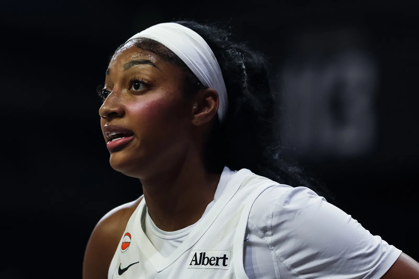 Angel Reese looks on during Dream game against Washington Mystics