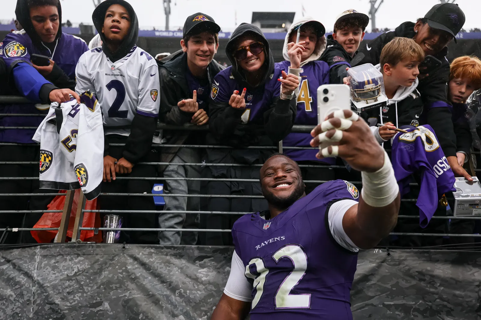 Nnamdi Madubuike #92 of the Baltimore Ravens takes a selfie with fans after the game against the Tennessee Titans on October 4, 2026, at M&T Bank Stadium in Baltimore, Maryland.