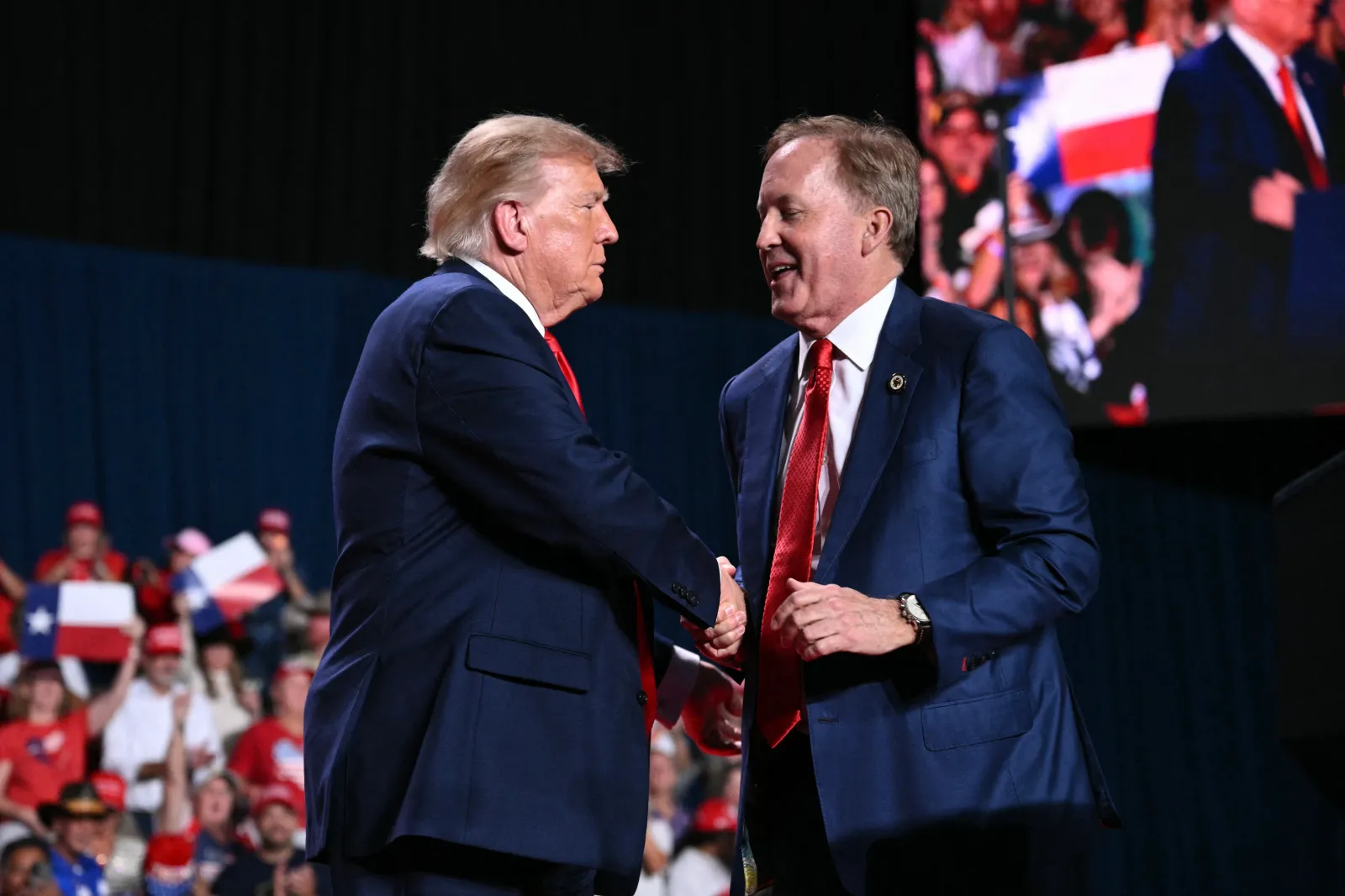 President Donald Trump shakes hands with Republican candidate for Senate Ken Paxton, right, during a campaign rally at the Freeman Coliseum in San Antonio on October 7, 2026.