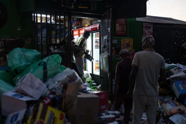 Looters remove goods from a shop following clashes between local residents and foreign nationals in Soweto, South Africa, on October 8, 2026.