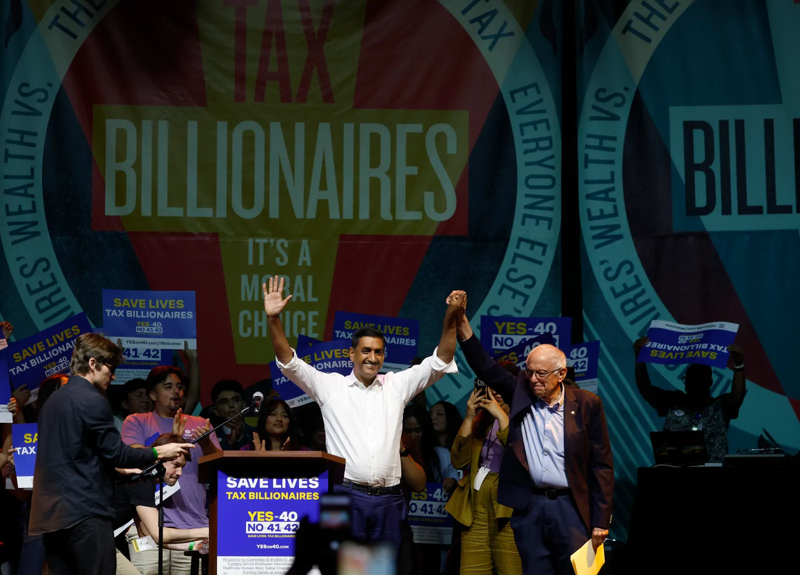 U.S. Sen. Bernie Sanders (R) (I-VT) raises his arms with U.S. Rep. Ro Khanna (L) (D-CA) during a "Ballots Over Billionaires" rally at The Novo on October 05, 2026 in Los Angeles, California. (Photo by Justin Sullivan/Getty Images)