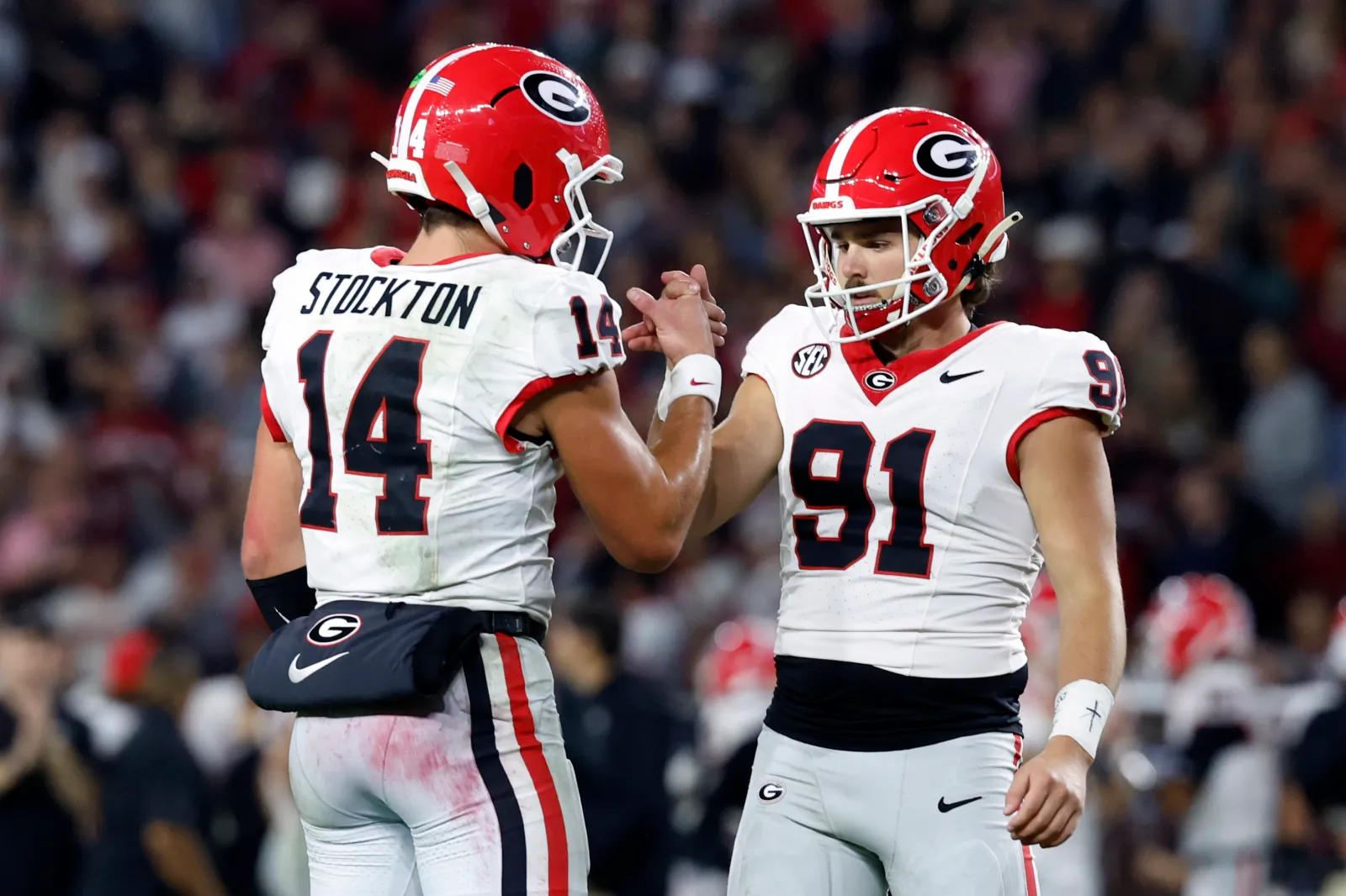 Quarterback Gunner Stockton #14 of the Georgia Bulldogs celebrates with kicker Peyton Woodring.